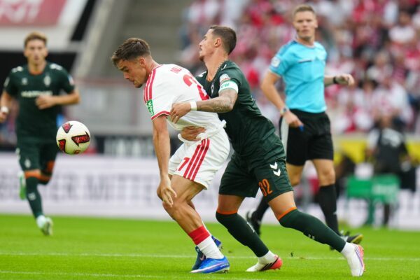Kölns Thijs Dallinga (l) und Bremens Marco Friedl kämpfen ums den Ball.